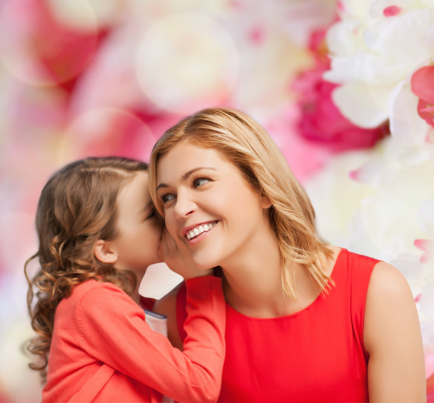 Smiling mother and daughter whispering gossip - Foto, Imagen