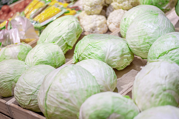 the cabbage in the boxes in the stores - Фото, изображение