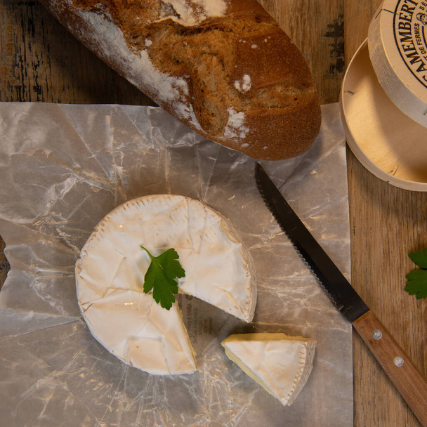 Camembert cheese on a wooden background - Photo, image