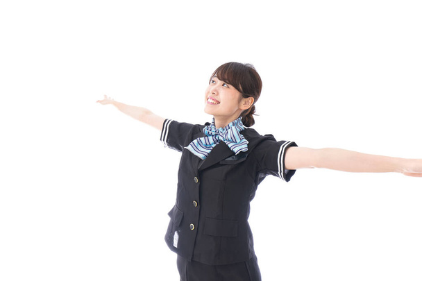 aziatische stewardess het verhogen van de hand omhoog geïsoleerd op witte achtergrond  - Foto, afbeelding