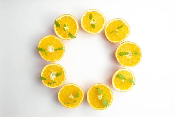 circle of fresh and sliced oranges on white background - Photo, Image