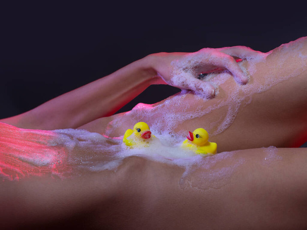 Sexy body. Hot girl. Temptation.Sexy girl in lingerie, erotica. Beautiful girl washing her body shower gel. Sexy girl with ducks and soap foam. Nude girl, naked woman - Φωτογραφία, εικόνα