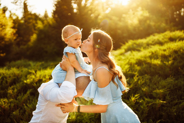Happy young family with baby girl  in the park - Foto, imagen