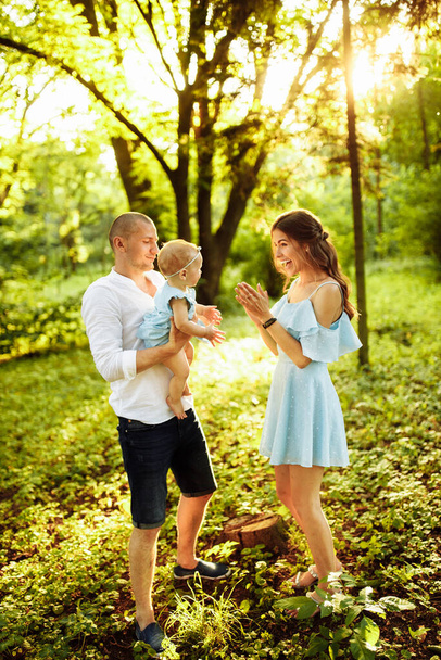 Happy young family with baby girl  in the park - Foto, Bild