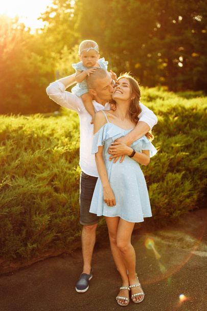 Happy young family with baby girl  in the park - Fotografie, Obrázek