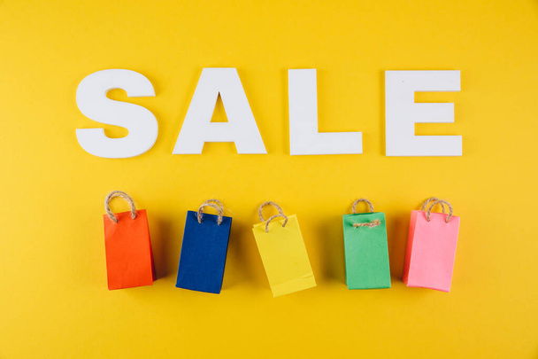 sale lettering and many small shopping bags - 写真・画像