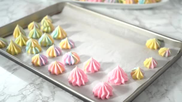 Step by step. Flat lay. Piping unicorn meringue cookies to the baking sheet lined with a parchment paper. - Footage, Video