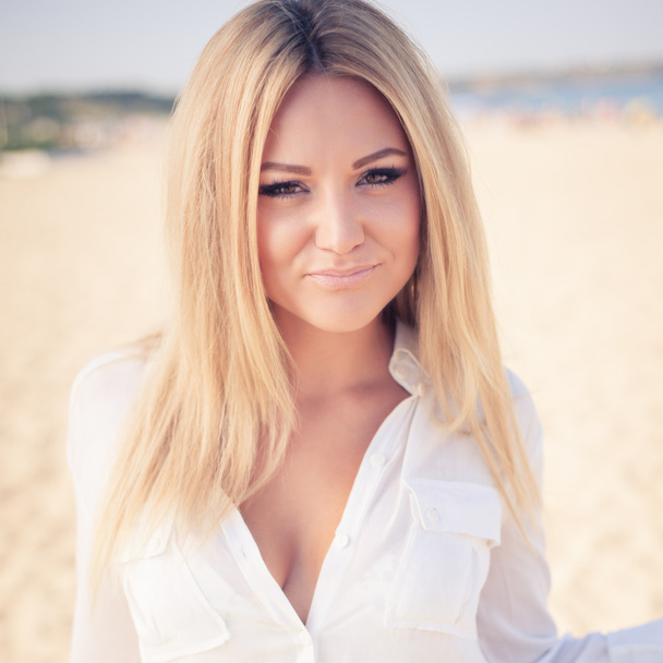  young beautiful woman blonde poses on a beach - Zdjęcie, obraz