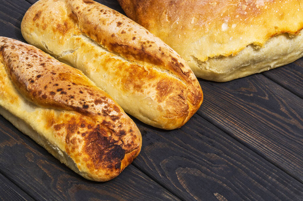 Bakeds loafs of Ukrainian national bread on a black table - Photo, Image