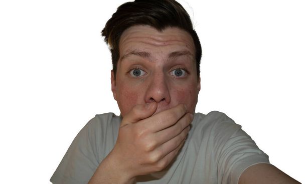 Guy puts hand in front of his mouth because he is scared - Photo, Image