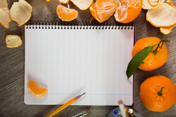 Notebook surrounded by fruit - 写真・画像