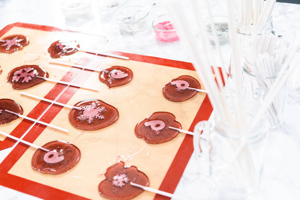 Making homemade berry flavor lollipops with snowflakes. - Photo, Image