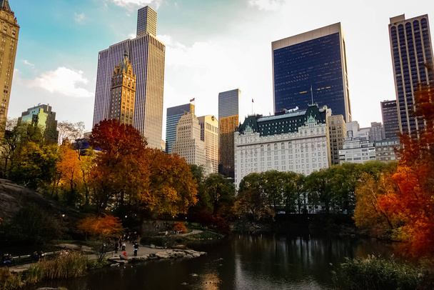 Central Park at the peak of the Autumn season in New York City with yellow and red leaves and trees changing colors at the peak of fall foliage. - Photo, image