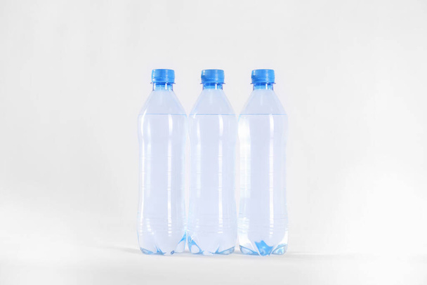 Plastic bottles with pure water on white background - Foto, immagini