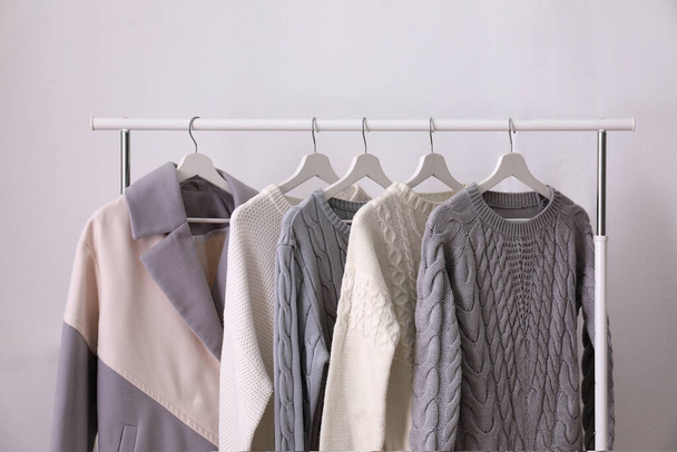 Rack with stylish warm clothes in room - Zdjęcie, obraz