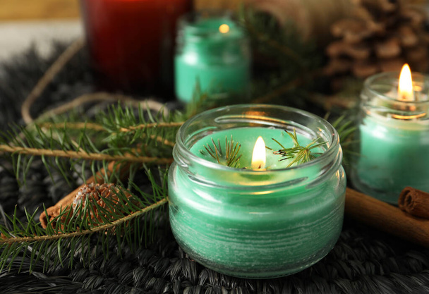 Burning scented conifer candles and Christmas decor on table - Zdjęcie, obraz