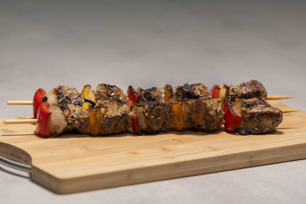 beef skewers on a wooden cutting board - Photo, Image