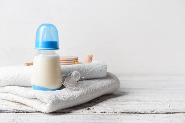 Bottle of milk for baby with accessories on table - Foto, immagini
