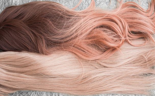 Wigs, natural and synthetic hair. Women's beauty concept. Close up photo of wig, hair for ladies  - Photo, Image