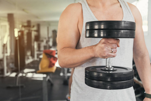 Man holding dumbbells.health and well-being concept. - Photo, Image