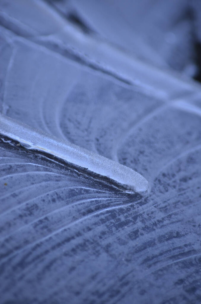 textuur gevormd door ijs, bevroren water dat een bijzondere achtergrond vormt - Foto, afbeelding