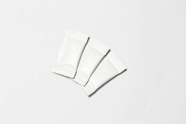 Close-up composition of white sachets on a white background. - Foto, immagini
