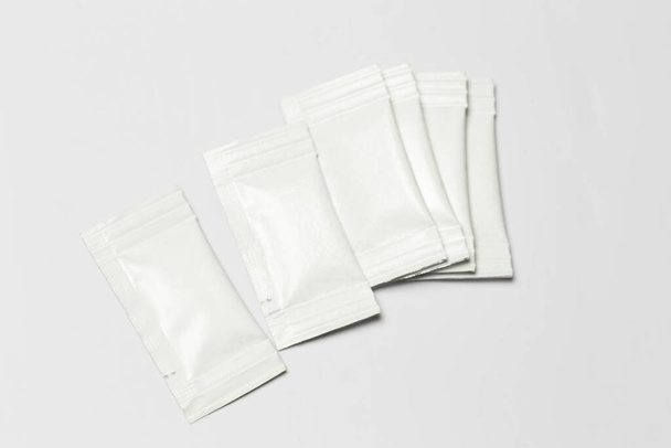 Close-up composition of white sachets on a white background. - Фото, зображення