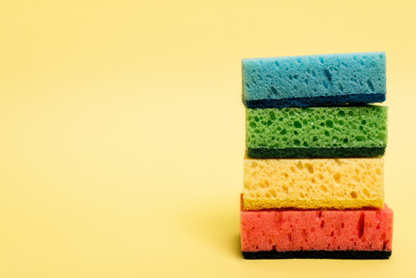 Close up view of colorful sponges on yellow background - Photo, Image
