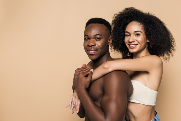 happy african american woman hugging boyfriend isolated on beige  - Photo, Image