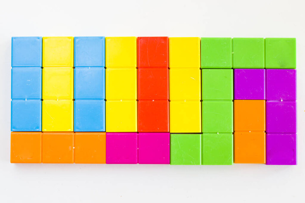 Colorful puzzle cubes background, geometric figures, table game, multicolored - Foto, imagen