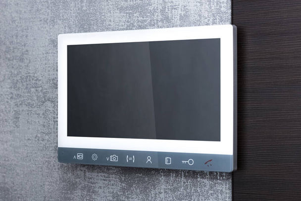 Video intercom screen on the wall. Security and safety concept in a modern apartment. Close-up - Zdjęcie, obraz