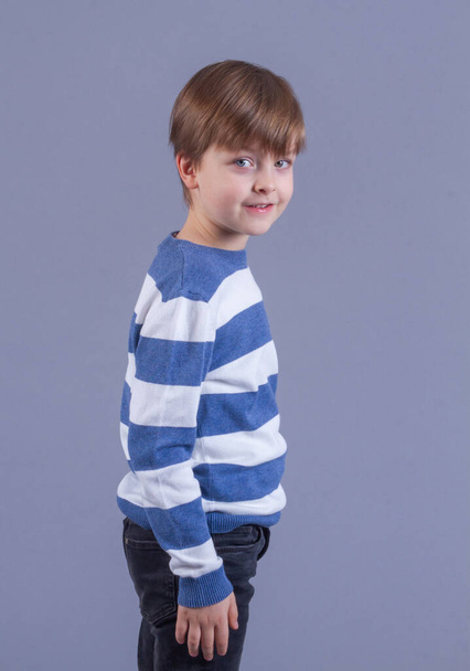 Portrait of a cute little boy with blond hair, a child smiling, happy childhood, model appearance. - Photo, Image