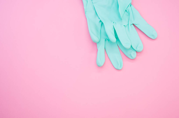 A top view shot of latex rubber gloves isolated on a pink background - new normal concept - Fotografie, Obrázek