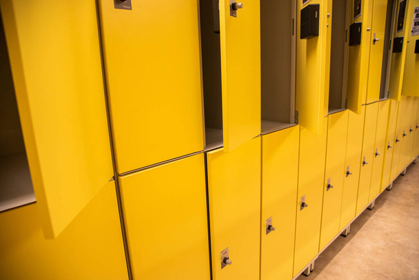 A closeup shot of yellow lockers in the gym - Photo, image