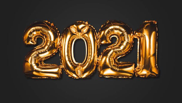 Happy New year 2021 celebration. Bright gold balloons figures New Year Balloons with glitter stars on dark background. Christmas and new year celebration. Gold foil balloons numeral 2021 and confetti - Zdjęcie, obraz