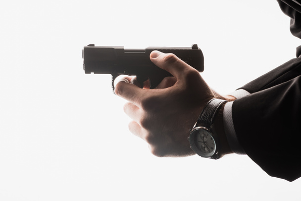 partial view of dangerous man holding gun isolated on white - Foto, afbeelding