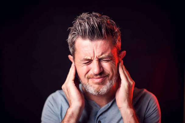 Man feels ear pain. People, healthcare and medicine concept - Photo, Image