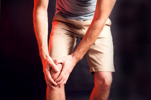 Man feels knee pain. People, healthcare and medicine concept - Photo, Image