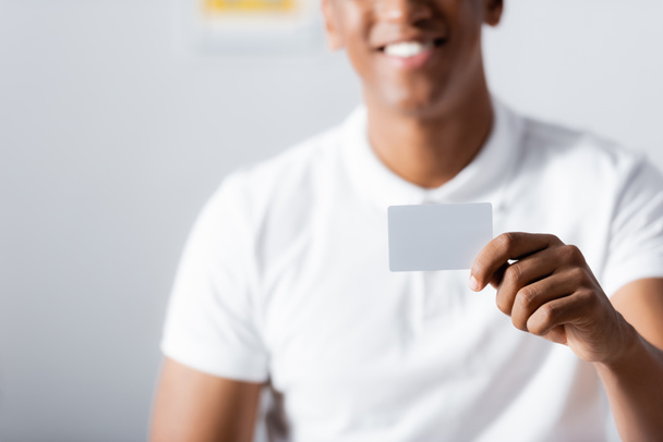 blank card in hand of cheerful african american therapist on blurred background - Photo, Image