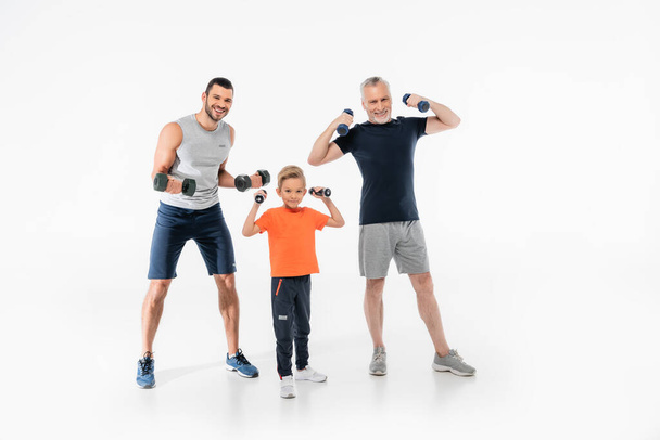 happy boy with grandfather and dad exercising with dumbbells on white - Φωτογραφία, εικόνα