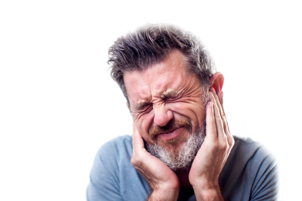 Man feels strong ear pain isolated. People, healthcare and medicine concept  - Foto, imagen