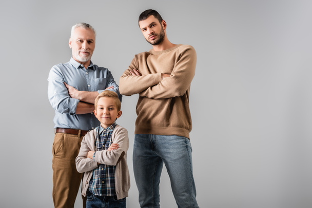 happy men and boy standing with crossed arms while looking at camera isolated on grey - Фото, зображення