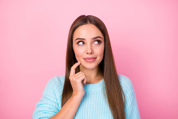 Closeup photo of attractive lady dreamer look side empty space hand on chin creative person wear knitted blue sweater isolated pastel pink color background - Φωτογραφία, εικόνα