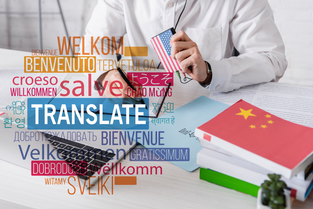 partial view of interpreter holding digital translator and writing in notebook, translate lettering near words in different languages illustration. Translation: "welcome" - Фото, зображення