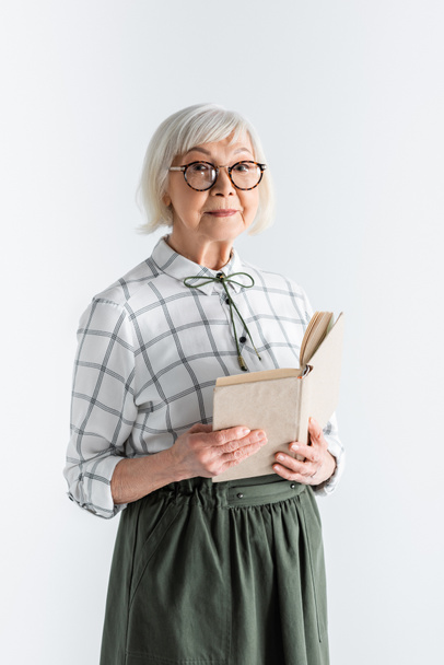 senior woman in glasses holding book isolated on white - Фото, зображення