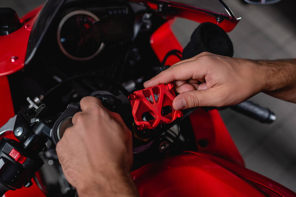 cropped view of mechanic checking motorcycle handlebar mechanism  - Foto, imagen