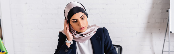 arabian translator in headset over hijab working in office, banner - Foto, afbeelding