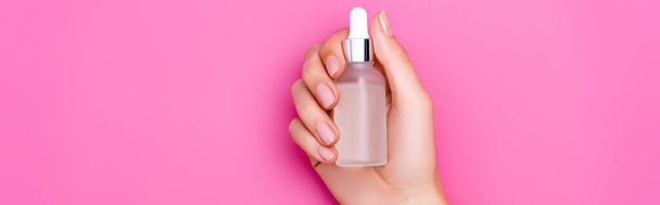 cropped view of woman with bottle of cuticle remover on pink background, banner - Fotografie, Obrázek