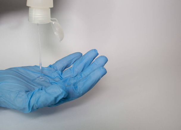 A closeup shot of hand cleanser and gloves - Foto, Bild