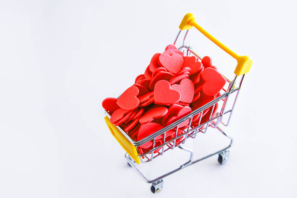 Shopping cart and Hearts on white background. Supporting customers and customer Service Concept. Shopping love. Valentines day concept - Foto, immagini